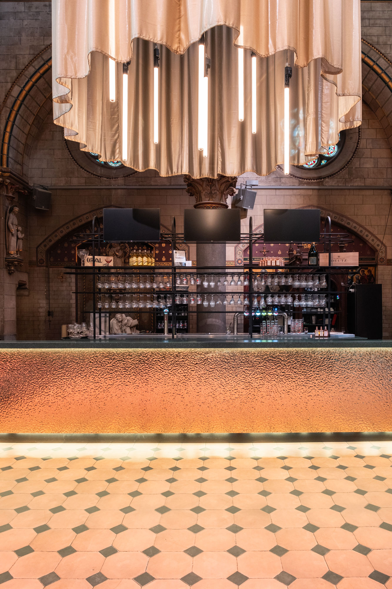 kerk als theaterfoyer bar en gordijn met verlichting interieurinrichting restauratie en herbestemming Antwerpen